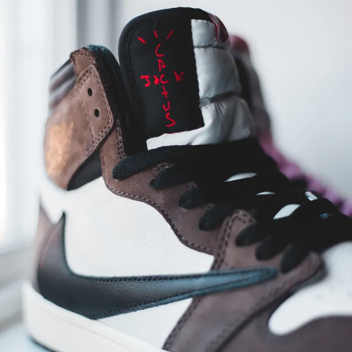 Brown and white suede sporty sneakers product photo on white surface