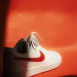 White sneaker product shot on vibrant red background